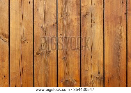 Stained wet deck wooden boards with water drops, brown planks texture