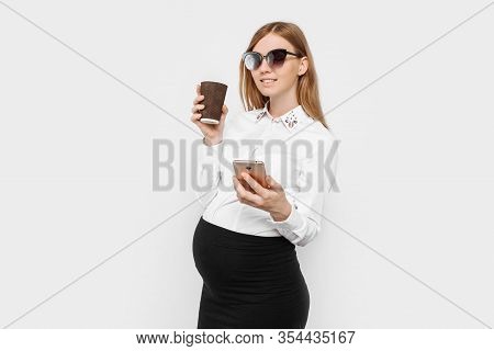 Image Of A Young Pregnant Businesswoman Wearing Glasses, A Girl Holding A Smartphone And Drinking Co