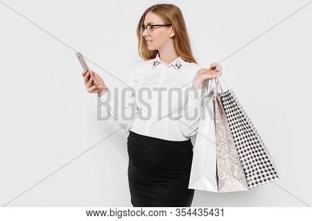 Image Of Young Pregnant Businesswoman Wearing Glasses Holding Smartphone And Bags Shopping