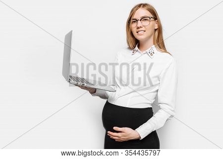 Image Of A Young Pregnant Businesswoman In Glasses Posing With A Laptop