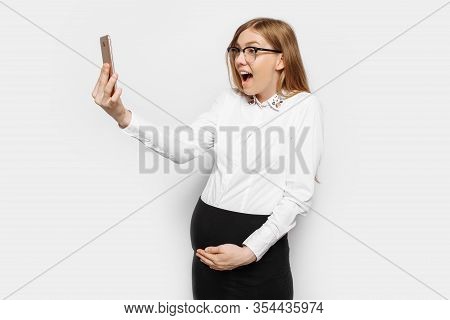 Image Of A Young Pregnant Businesswoman In Glasses, A Girl Holding A Mobile Phone And Looking At Him