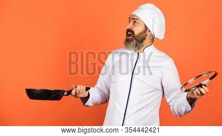 High Quality Frying Pan. Bearded Man Cook White Uniform. Cooking Like Pro. Regular Cooking. Easy Tas