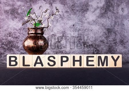 Blasphemy Word Made With Building Blocks On A Grey Background
