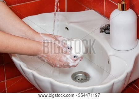 Effective Hand Washing With Soap To Reduce The Risk Of Common Infections. Female On Bathroom Sink Wi