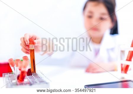 Asian Scientist Working In Science And Chemical For Health. Doctor With Virus In Lap Test To Protect
