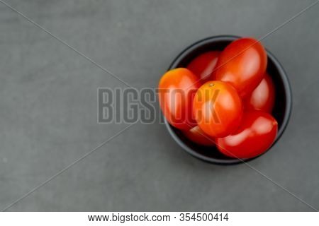 Cherry Tomatoes In Mini Black Bowl To Prepare For Cooking. Concept Of Ingredient In Thai Food