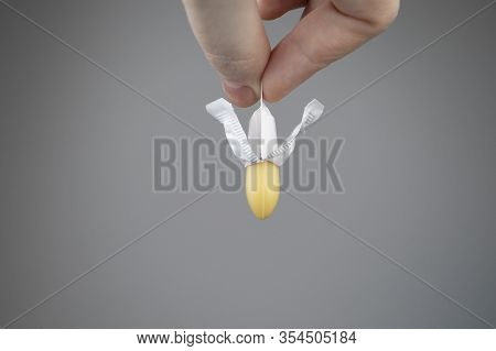 Vaginal Or Rectal Candle In Hands On A Light Background. The Drug Is In The Form Of Suppositories. T
