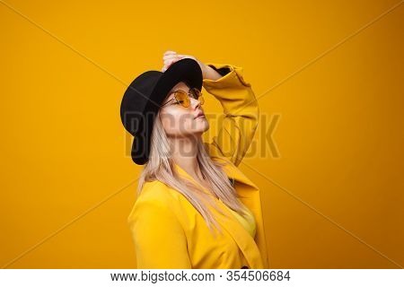 Stylish Trending Young Woman In Bright Clothes On Yellow Background, Copy Space. Cool Blonde Girl In