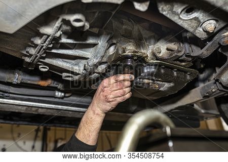 The Car Mechanic Bolts A New Screw With A Copper Washer To The Oil Sump, In A Diesel Engine.