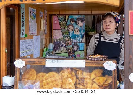 Takayama, Japan - April 26, 2014: Saleswoman Inside His Senbei Store At The Miyagawa Morning Market.