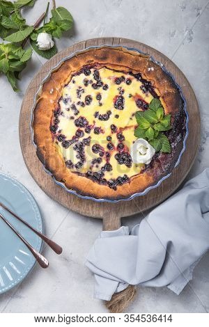 Clafoutis - Traditional French Berries Pie, Dessert On Rustic Wooden Table. Clafouti - Traditional F