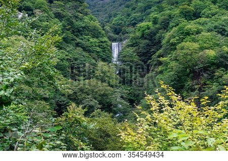 Green Summer Forest Landscape With Large Waterfall. Kegon Falls In Nikko, Japan