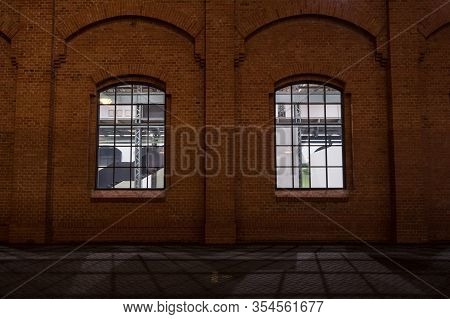 Facade Of A Vintage Old Red Brick Warehouse, Used From An Industrial Revolution Era Facotry Plant, W