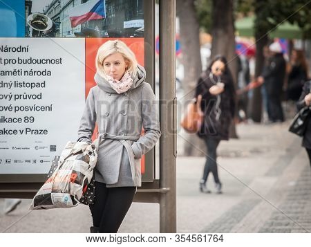 Prague, Czechia - October 31, 2019: White Caucasian Young Woman, Blonde, Waiting In The Streets Of P