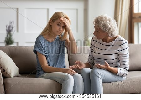 Authoritative Mature Mom Lecturing Frustrated Grownup Daughter