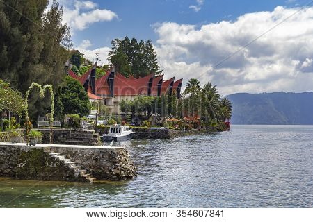 Parapat, Indonesia - December 31, 2019. Guest Houses In The Form Of A Traditional Indonesian Dwellin