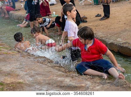 Children Playing In Green Mubazzarah Chalets, Al Ain, Abu Dhabi In 28/02/2014
