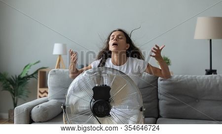 Young Woman Breathe Fresh Air Form Floor Fan