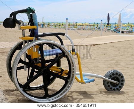 Special Wheelchair With Aluminum Wheels To Move On The Sand Of The Beach