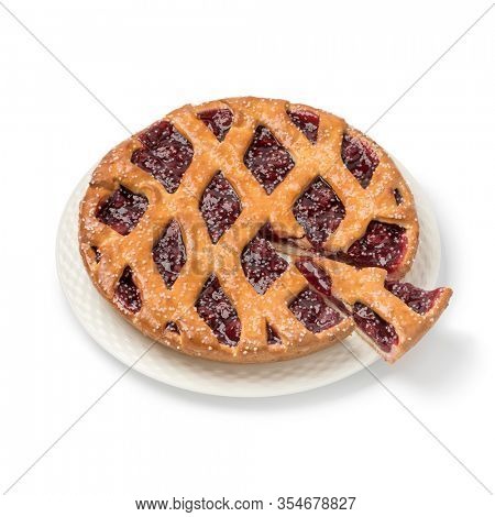 Fresh baked Limburg cherry vlaai and a piece isolated on white background