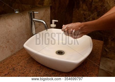 A Boy Washes Hands In A Sink With Soap And Running Water. Washing Hands Is An Important Step In The 