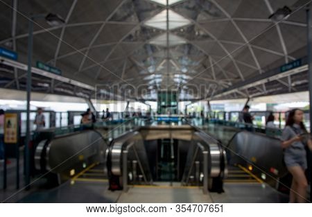 Defocussed View Of Escelator And People At Railway Station.  Defocussed Background Of Subway Station