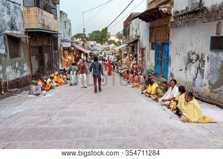 Vrindavan, India - March 20, 2019: People Sitting On The Street Near Govind Dev Ji Temple And Asking