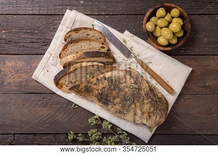 Fresh Italian Ciabatta Bread  For Leaven With Herbs, Olives On Wooden Background, Top View, Copy Spa