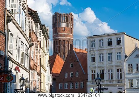 LÜneburg, Niedersachsen, Germany - Juli 27, 2018:
Half-timbered Red Brick Houses Near The River On T