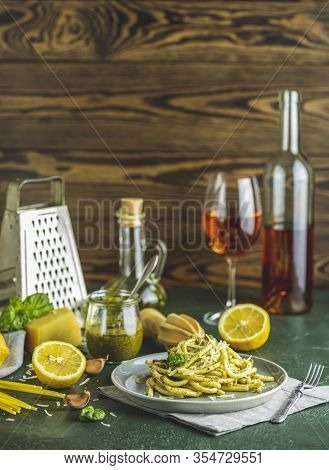 Gray Plate Of Spaghetti Pasta Bucatini With Pesto Sauce And Parmesan. Italian Traditional Perciatell