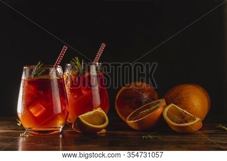 Two Glasses With Water Drops Of Campari Gin Spritz. Cocktail Of Sweet, A Touch Of Bitter From The Ca