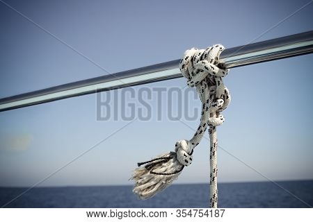 Marine Knot Detail Stainless Steel Boat Railing. Marine Fender Knot Around Boat Lee. Close-up Nautic