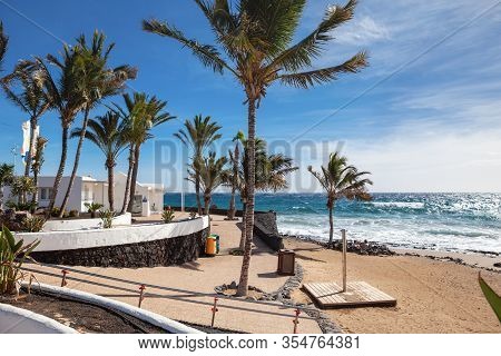 Puerto Del Carmen Beach In Lanzarote, Canary Islands, Spain. Blue Sea, Palm Trees, Selective Focus
