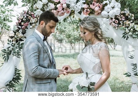 The Bride And Groom Exchange Vows And Wedding Rings At The Wedding Ceremony. Selective Focus. Film G
