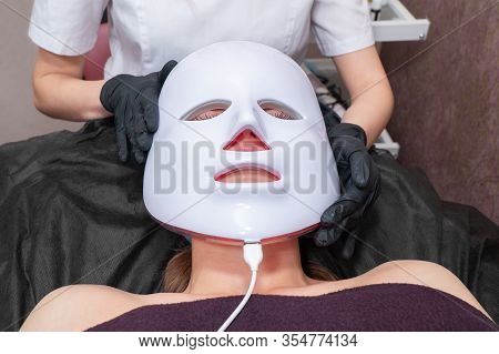 Beautician Puts Mask On Patient Face For Light Treatment Procedure