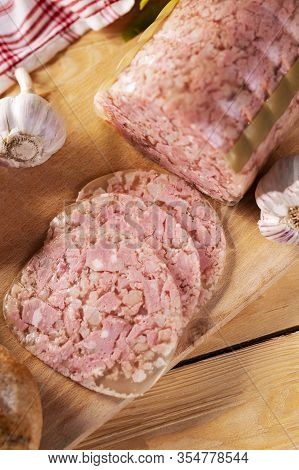 Headcheese On Wooden Cutting Board, Top View. Brawn. Pork Cold Cuts.