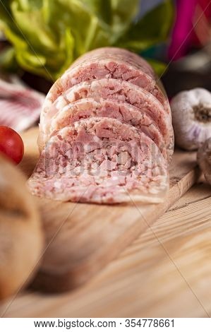 Brawn On Wooden Cutting Board. Headcheese. Pork Cold Cuts.