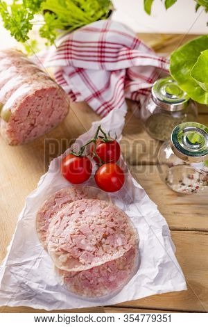 Rustic Composition With Sliced Headcheese On A Paper. Brawn. Pork Cold Cuts.