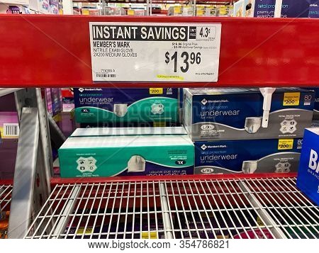 Orlando,fl/usa-3/7/20: A Sign That Says Limit 4 Per Membership On An Empty Shelf Of Exam Gloves At A