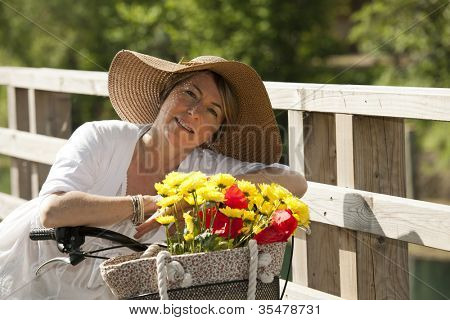 Woman on her bike with colorful flowers