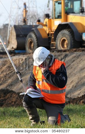 Site surveyor taking readings