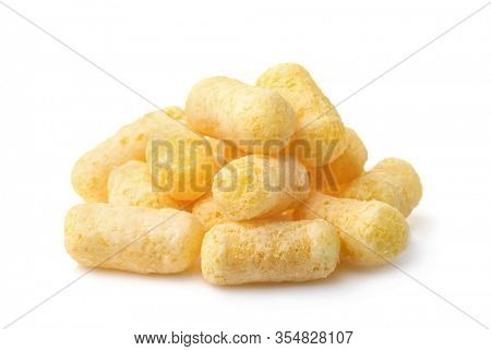Plie of puffed corn snacks isolated on white