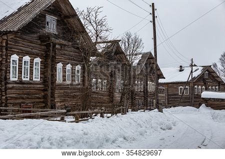 Street Of Russian Ancient Two-storied Wooden Houses In Kizhma Village. Arkhangelsk Region, Russia