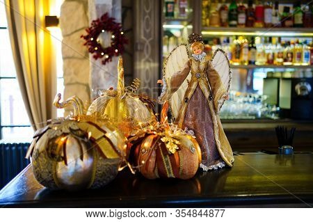 Pumpkins And Angel Girl Christmas Decor At The Reception Desk