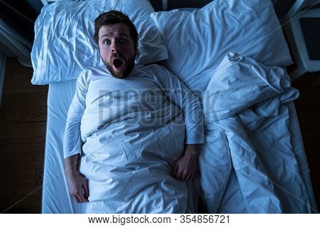 Man Had A Nightmare, He Woke Up And Screamed In Horror, Scaredly Looking Into The Camera With Big Ey