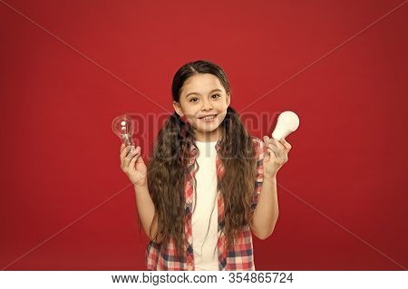 Eco Life. Lighting Choice. Little Girl Light Bulbs On Red Background. Symbol Of Idea Progress And In