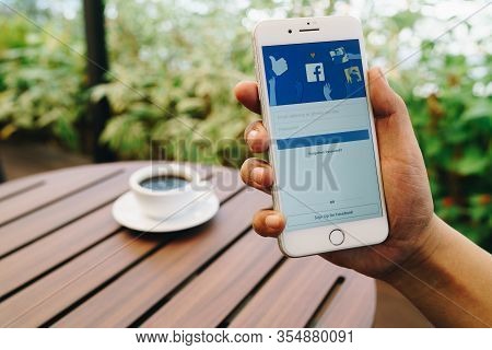Chiang Mai, Thailand - Feb.17,2020: Man Holding Apple Iphone With Facebook App On The Screen. Facebo