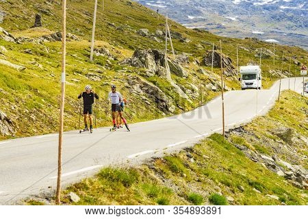 Sognefjellet, Norway - July 7, 2018: People Riding On Roller Skis In Mountains On National Tourist R