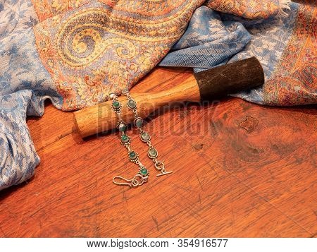 Green Onyx Bead Bracelet In Silver, With Indian Skarf And Wooden Striker On Wooden Table Background