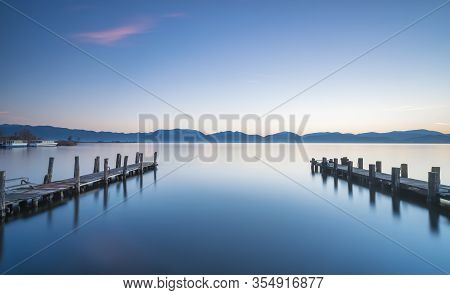 Two Wooden Piers Or Jetties And Lake At Sunrise. Torre Del Lago Puccini, Versilia, Massaciuccoli Lak